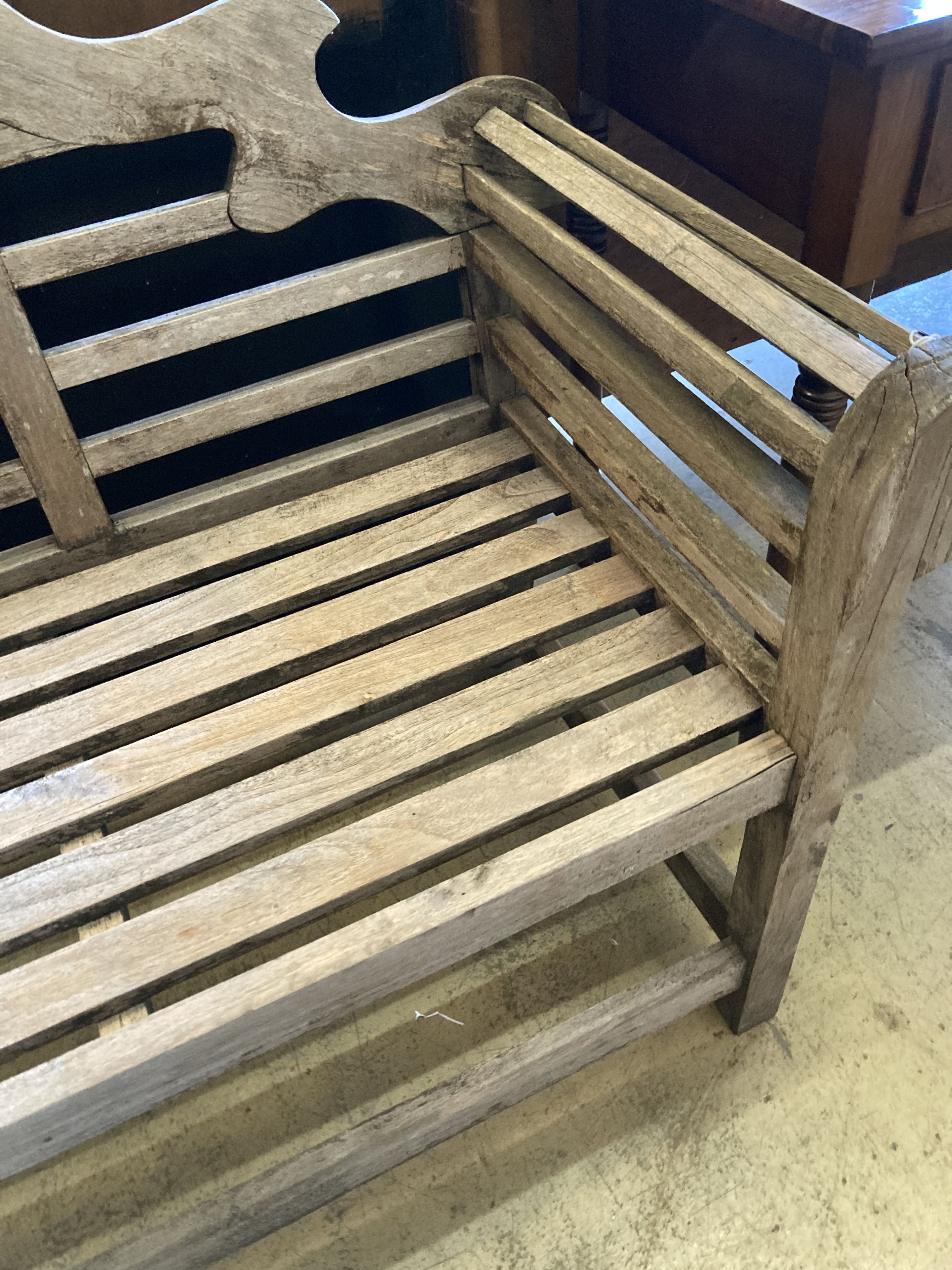 A Lutyens style weathered teak garden bench, length 166cm, depth 58cm, height 105cm